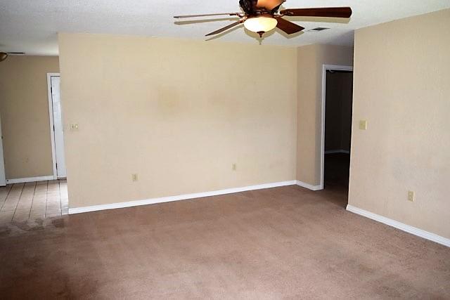 123 Oak Terrace Drive Crestview, FL 32539 - Photo 4 of 21 an empty room with a ceiling fan and wooden floor