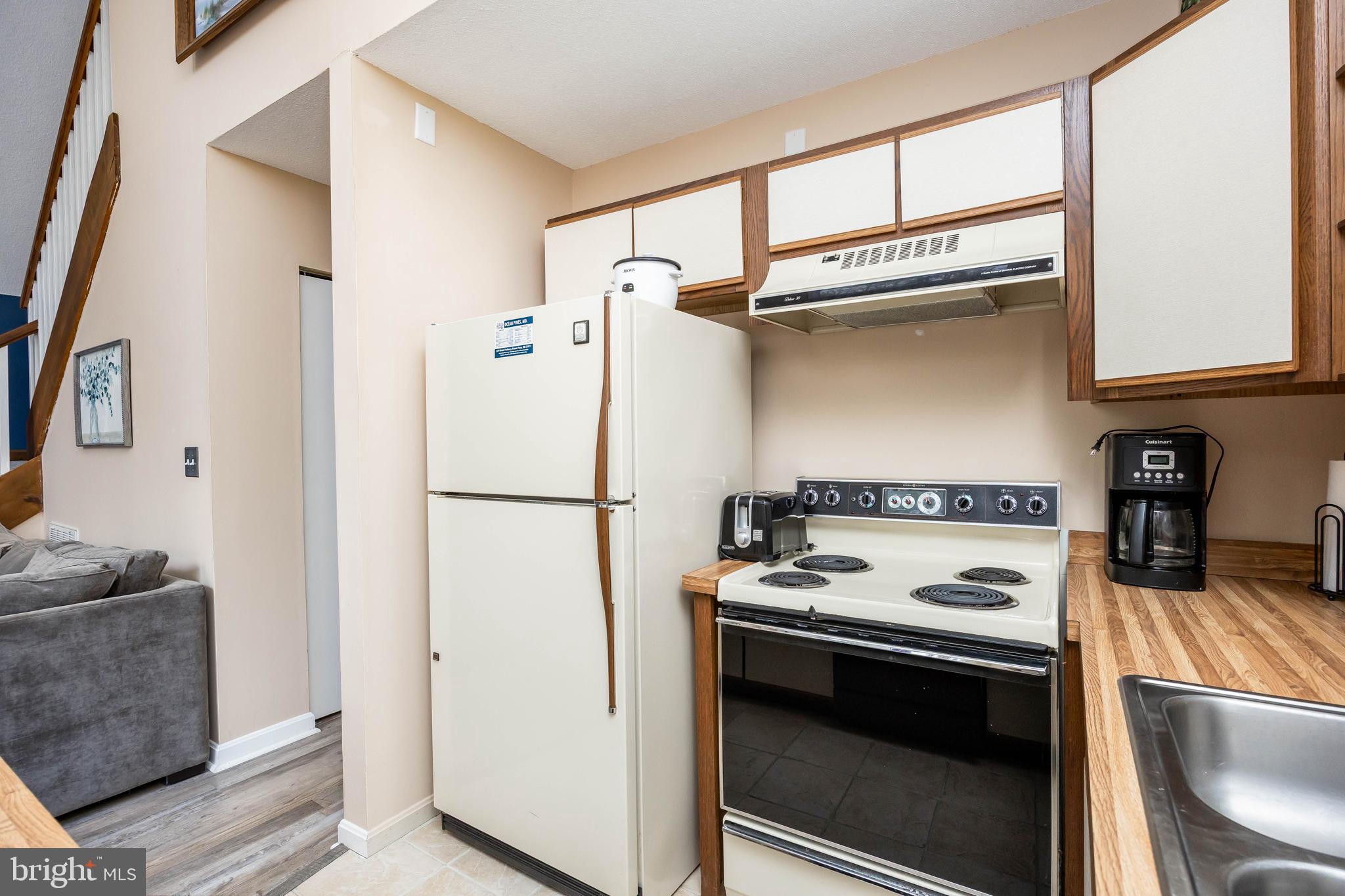 54 Falcon Bridge Road Ocean Pines, MD 21811 - Photo 36 of 53 a white refrigerator freezer and a stove sitting inside of a kitchen
