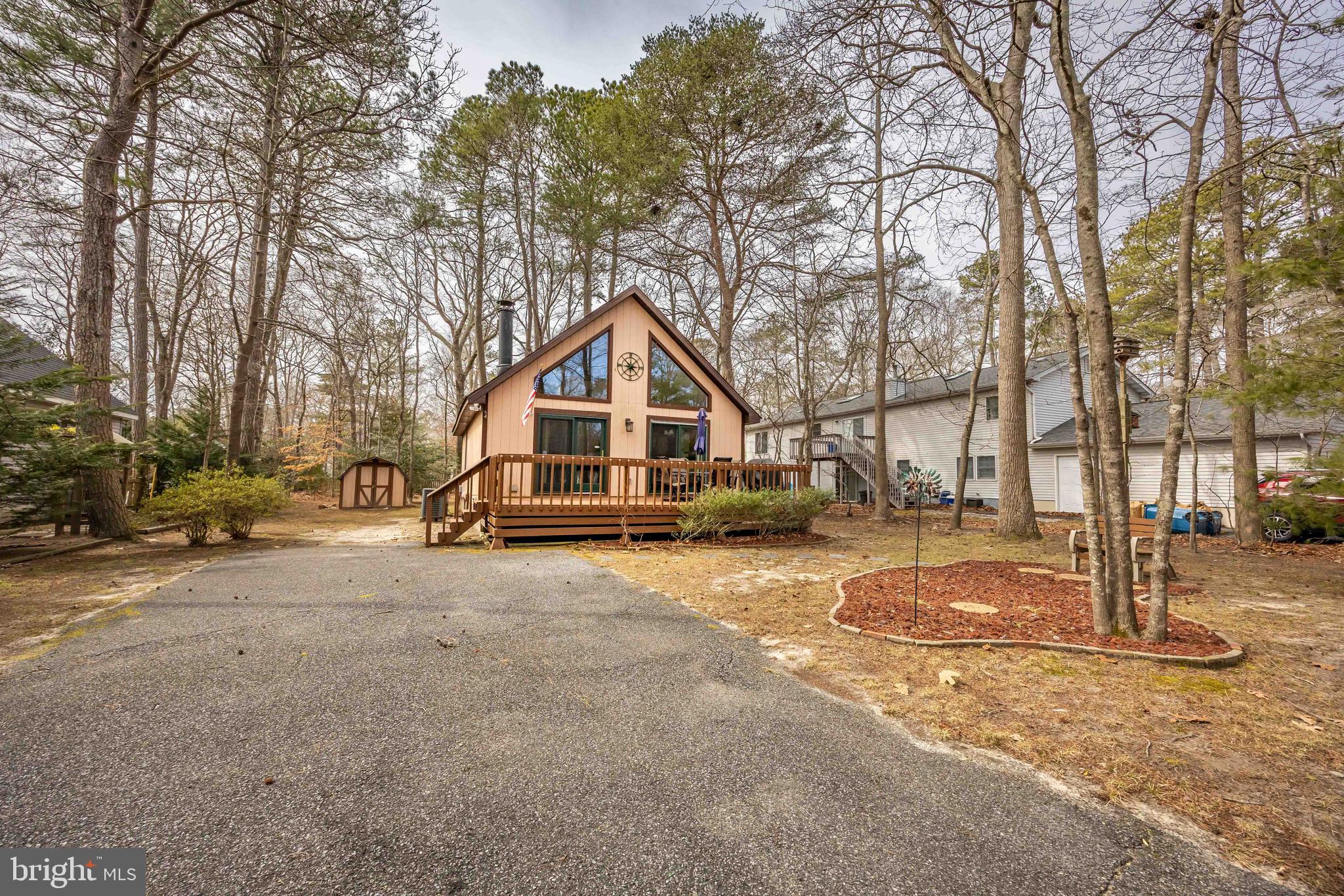 54 Falcon Bridge Road Ocean Pines, MD 21811 - Photo 50 of 53 a house with trees in front of it