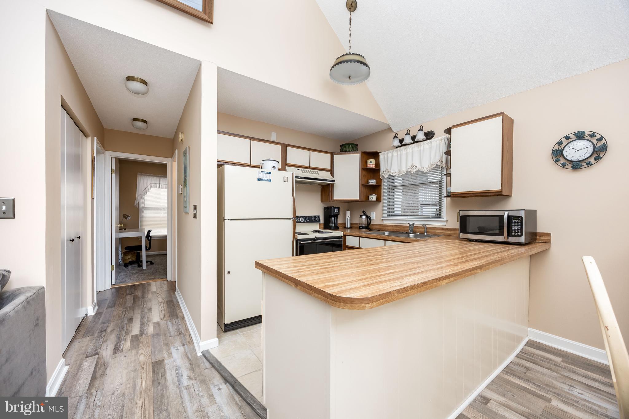 54 Falcon Bridge Road Ocean Pines, MD 21811 - Photo 6 of 53 a kitchen with kitchen island a refrigerator stove and sink
