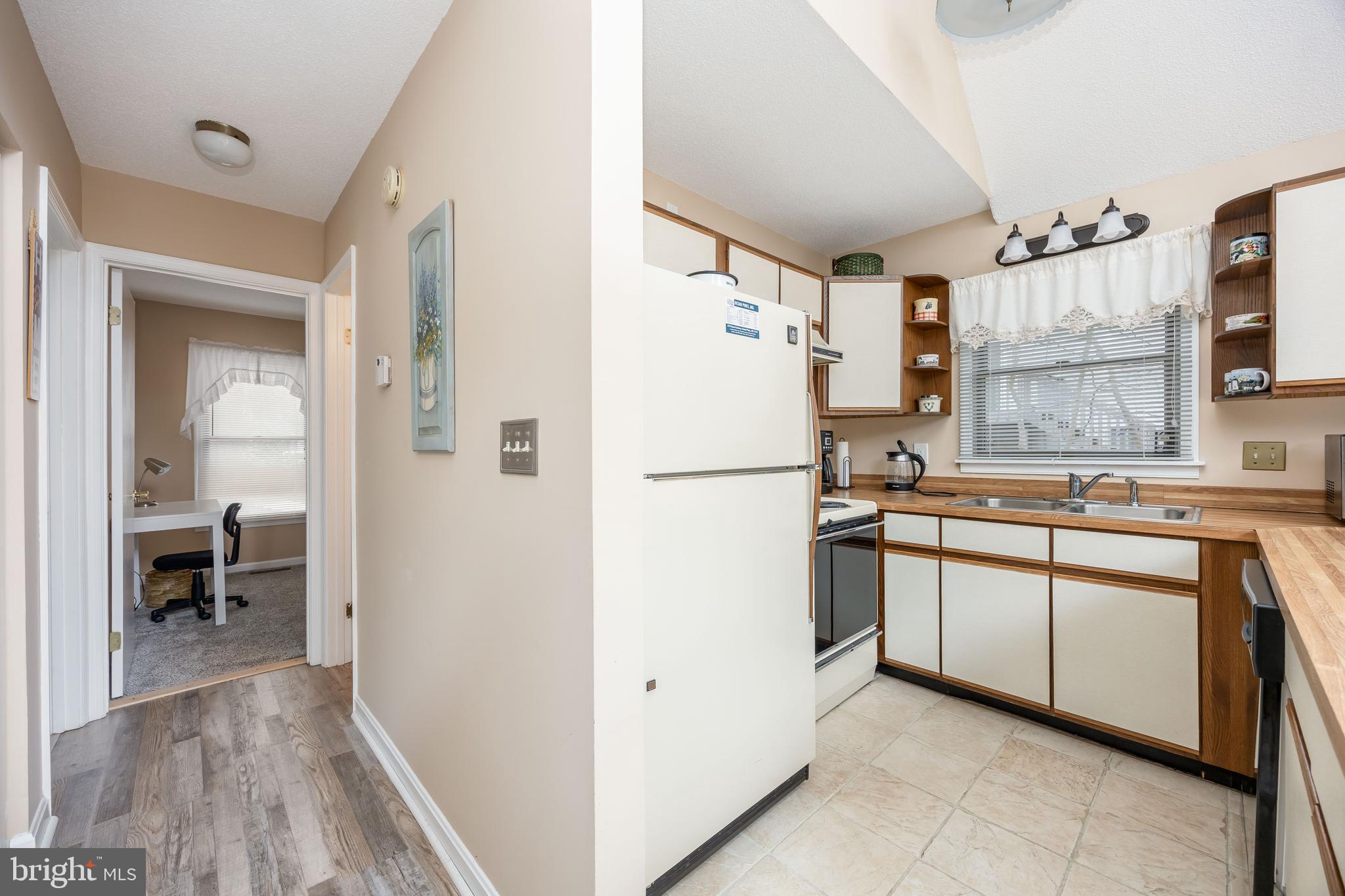 54 Falcon Bridge Road Ocean Pines, MD 21811 - Photo 7 of 53 a kitchen with stainless steel appliances a refrigerator sink and cabinets