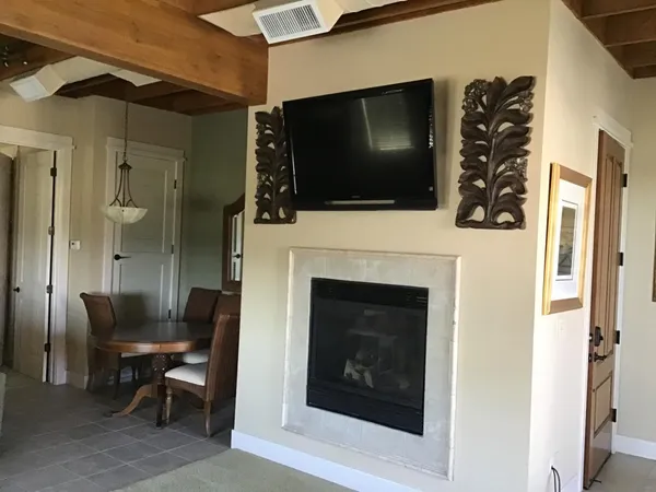 a living room with a fireplace and a flat screen tv