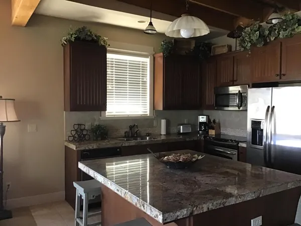 a kitchen with a sink stove and microwave