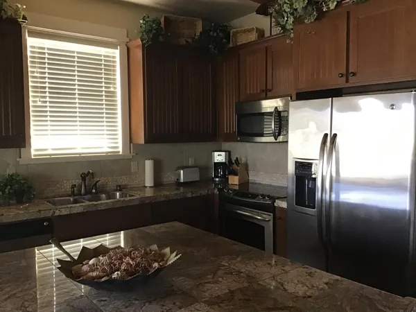 a kitchen with a sink stove and refrigerator