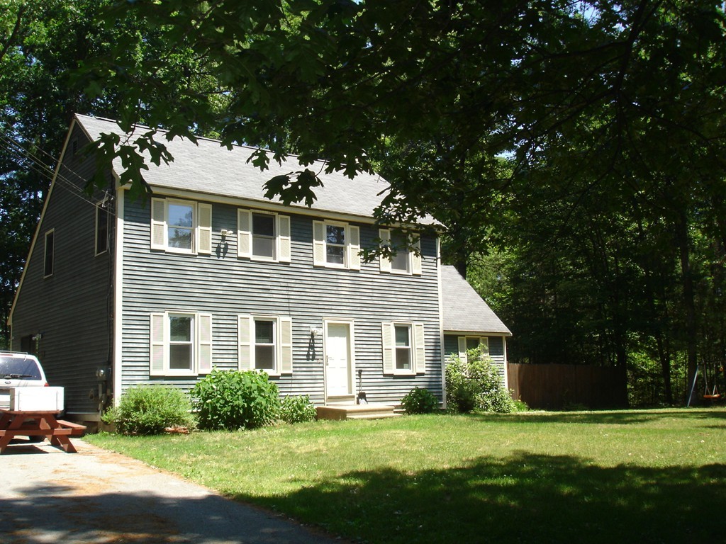 84 Groton School Road Ayer, MA 01432 - Photo 3 of 14 a front view of a house with a garden
