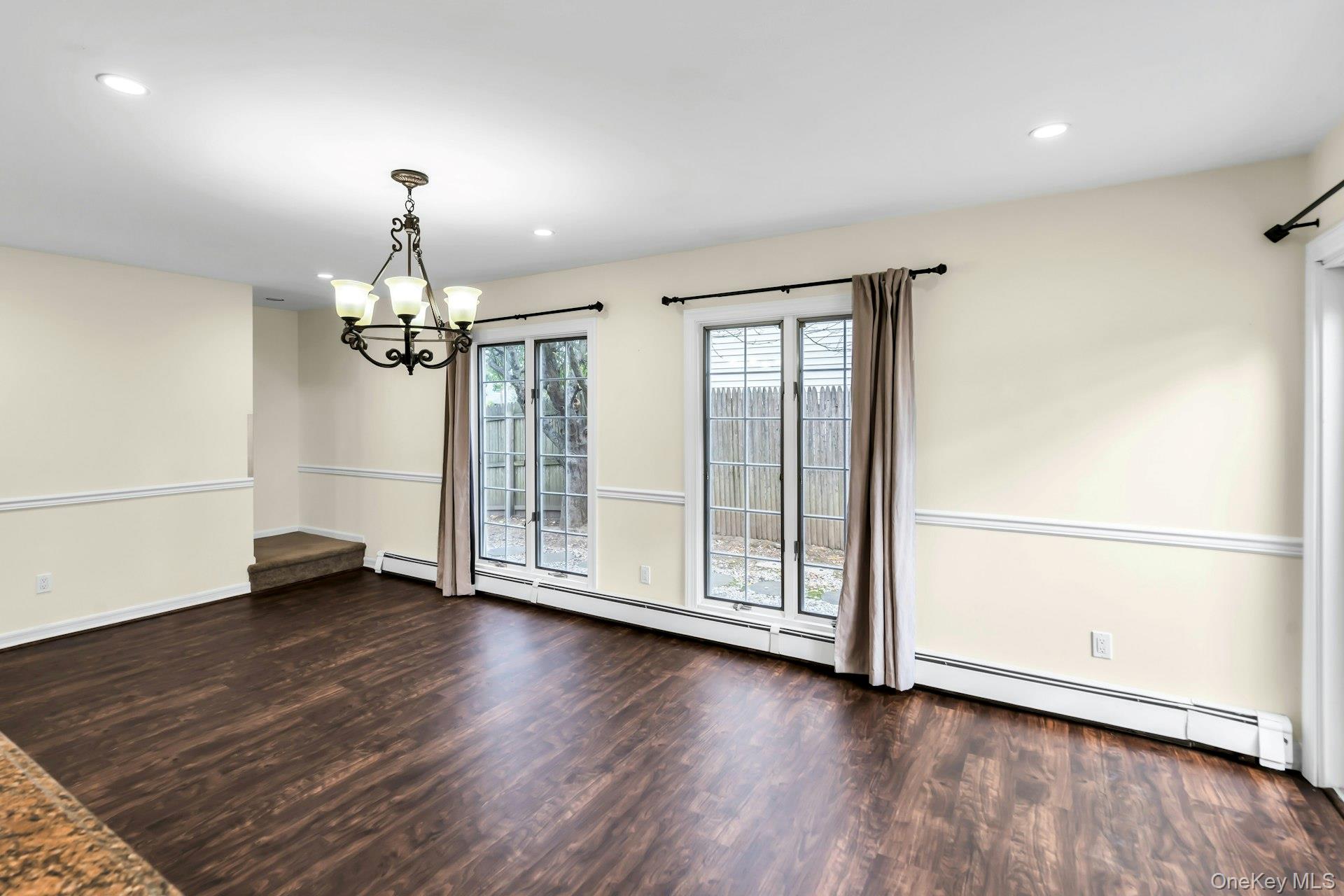 4 Greenway Drive Syosset, NY 11791 - Photo 11 of 29 an empty room with wooden floor chandelier and windows