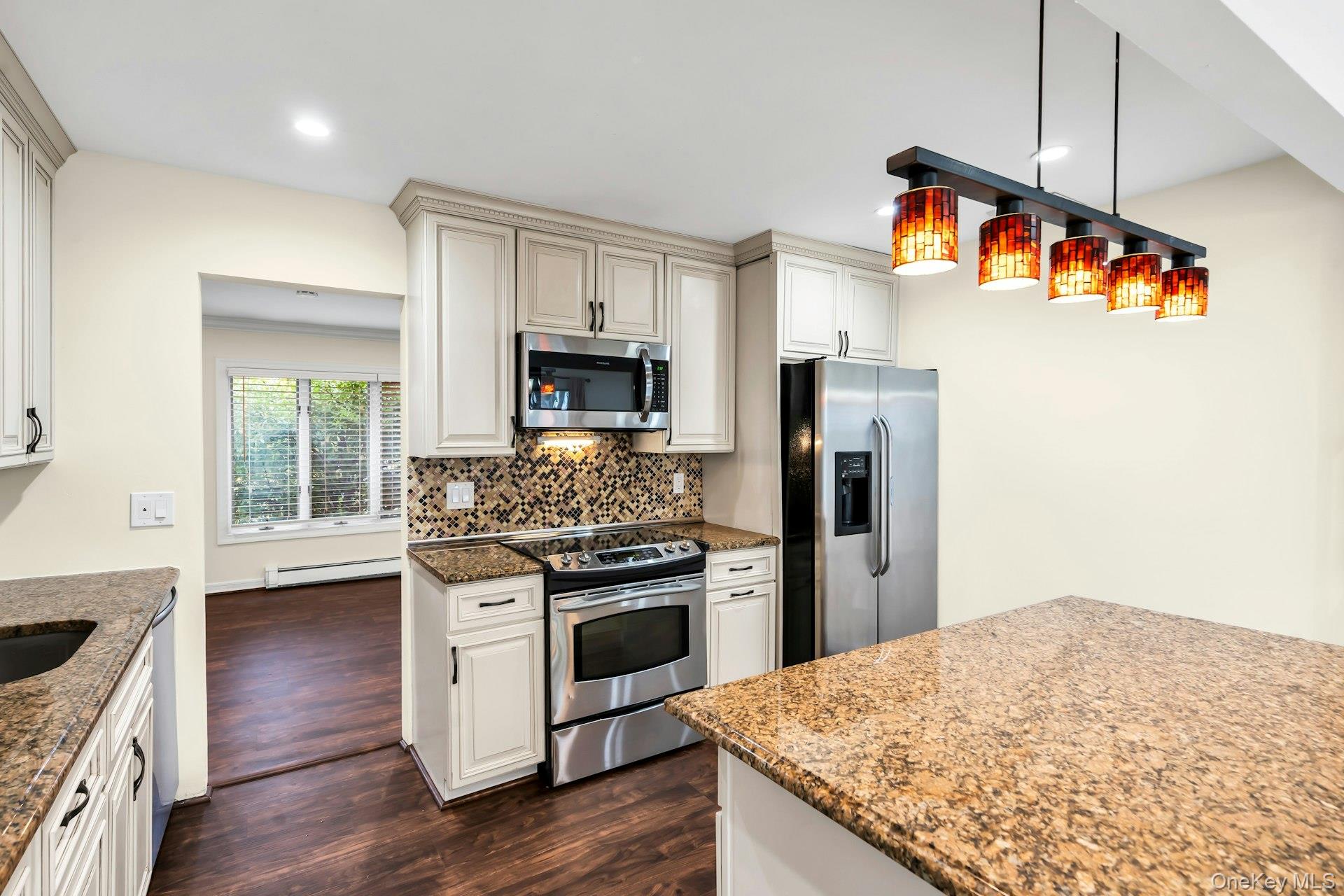 4 Greenway Drive Syosset, NY 11791 - Photo 12 of 29 a kitchen with stainless steel appliances granite countertop a stove and a refrigerator