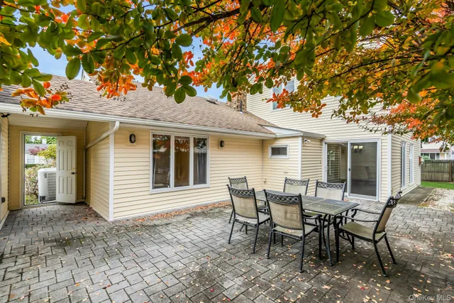 a view of a house with backyard and sitting area