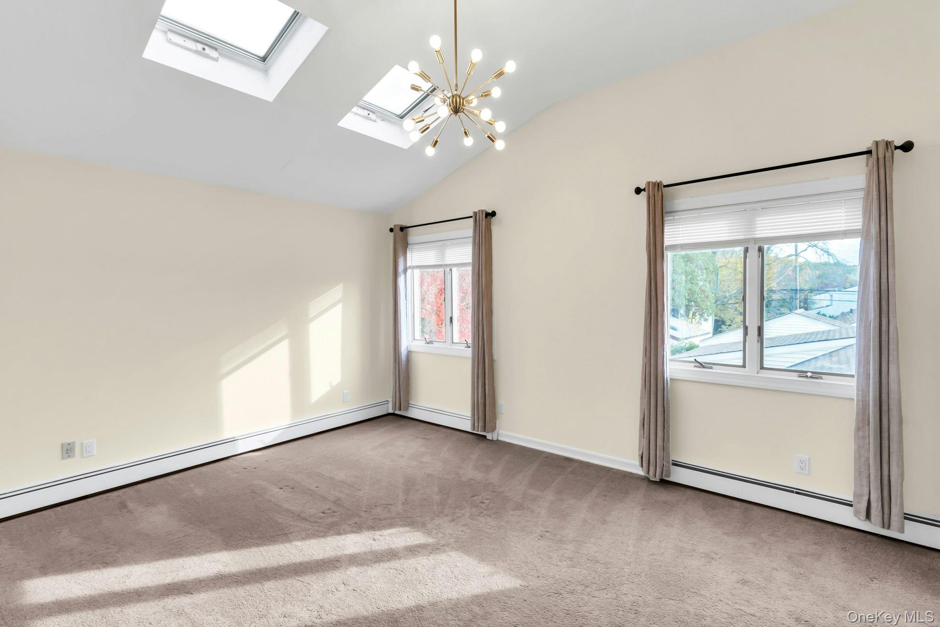 4 Greenway Drive Syosset, NY 11791 - Photo 24 of 29 an empty room with chandelier and windows