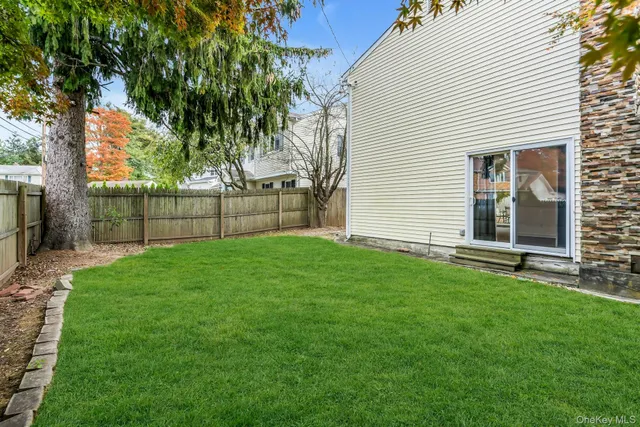 a view of a backyard with a large tree