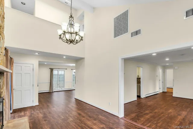 a large kitchen with cabinets wooden floor and stainless steel appliances