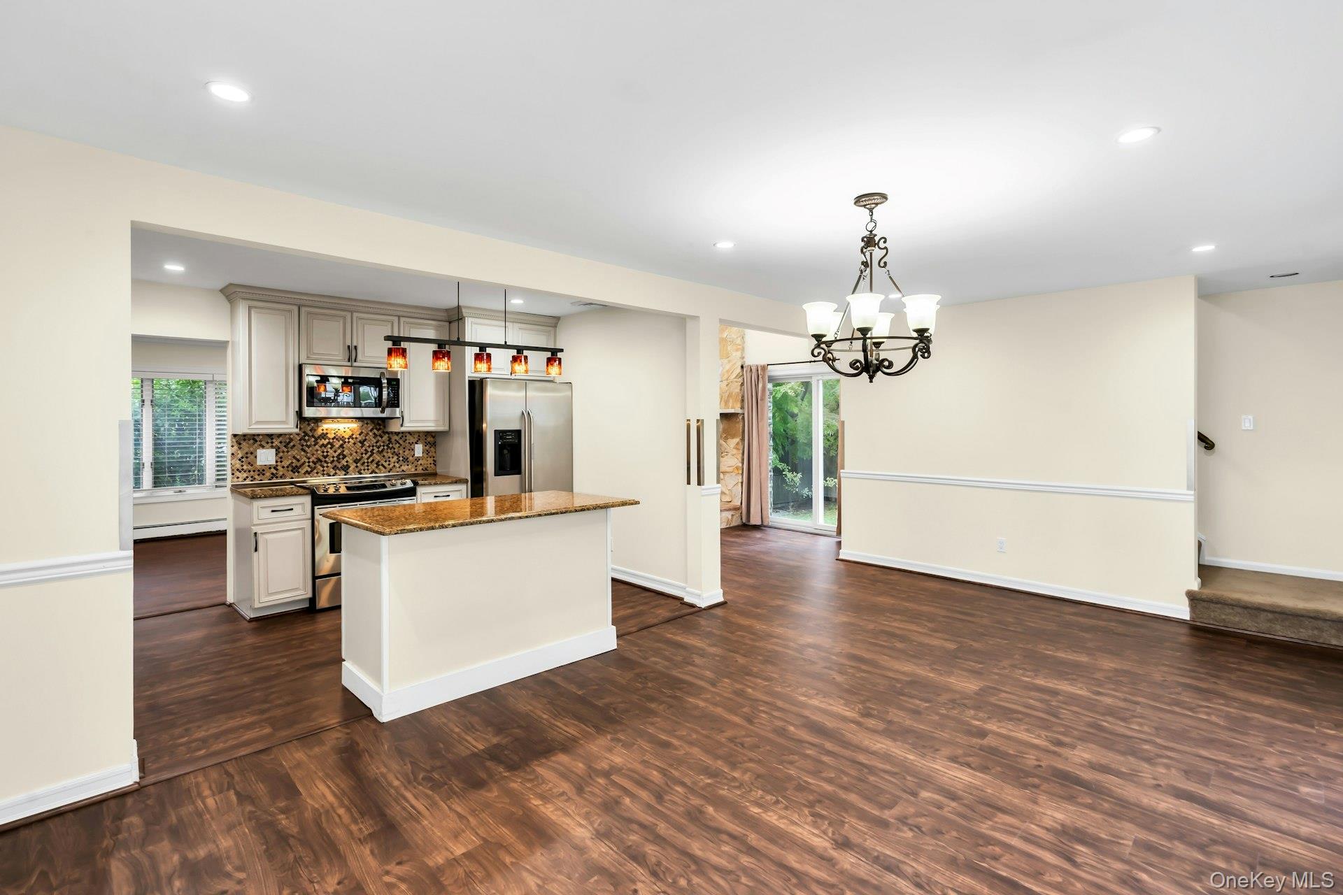 4 Greenway Drive Syosset, NY 11791 - Photo 5 of 29 a large kitchen with cabinets wooden floor and stainless steel appliances