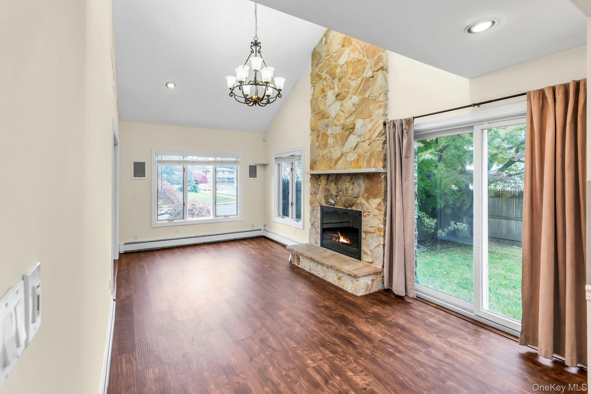 4 Greenway Drive Syosset, NY 11791 - Photo 6 of 29 a view of a livingroom with wooden floor a fireplace and window