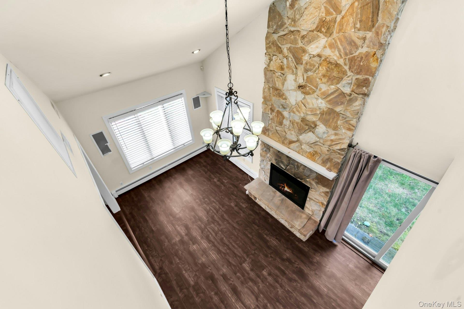 4 Greenway Drive Syosset, NY 11791 - Photo 9 of 29 a living room with a fireplace furniture a flat screen tv and a window