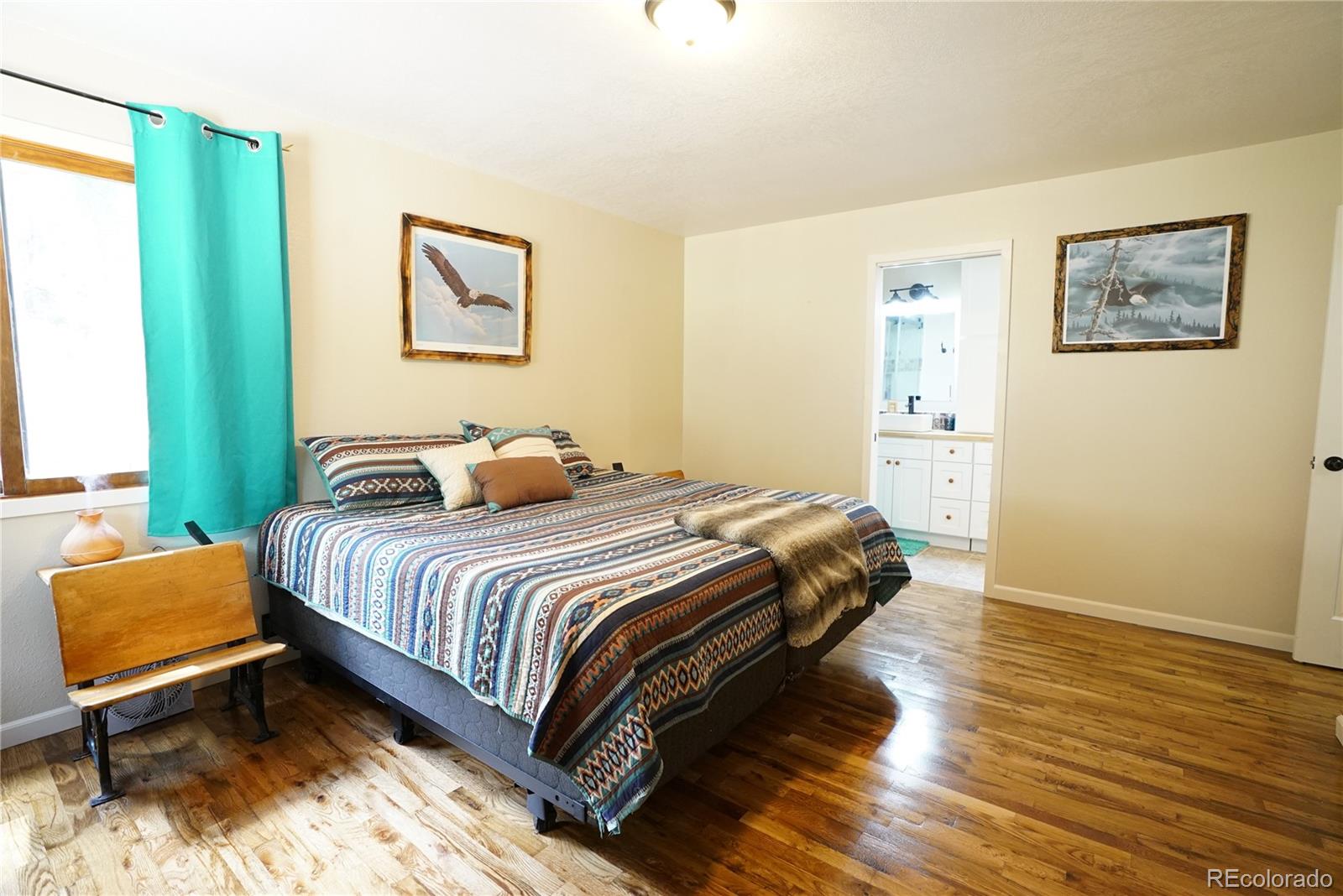 336 County Road 64 Shawnee, CO 80475 - Photo 14 of 40 a bedroom with a bed and wooden floor