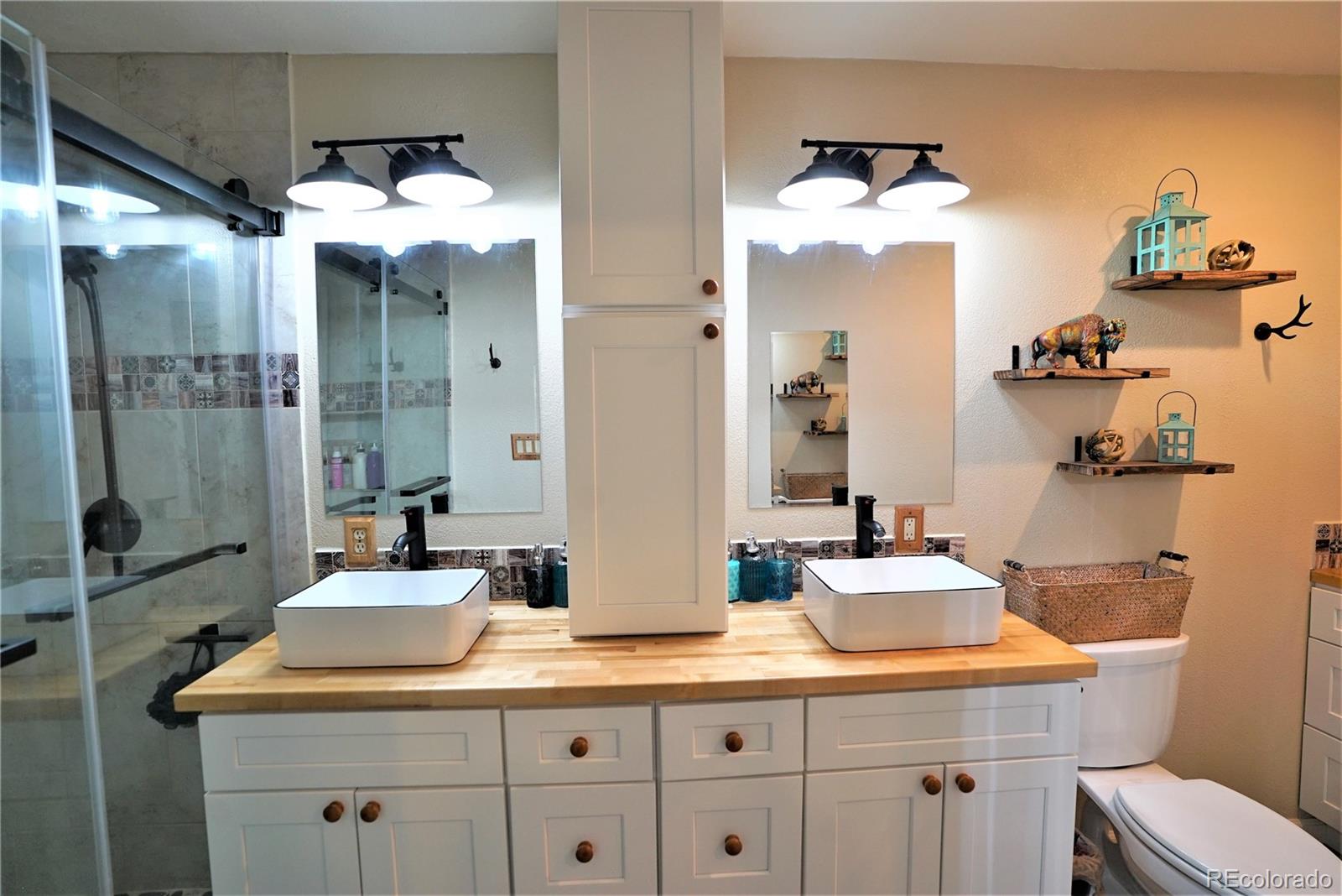 336 County Road 64 Shawnee, CO 80475 - Photo 16 of 40 a bathroom with a sink and mirror with toilet