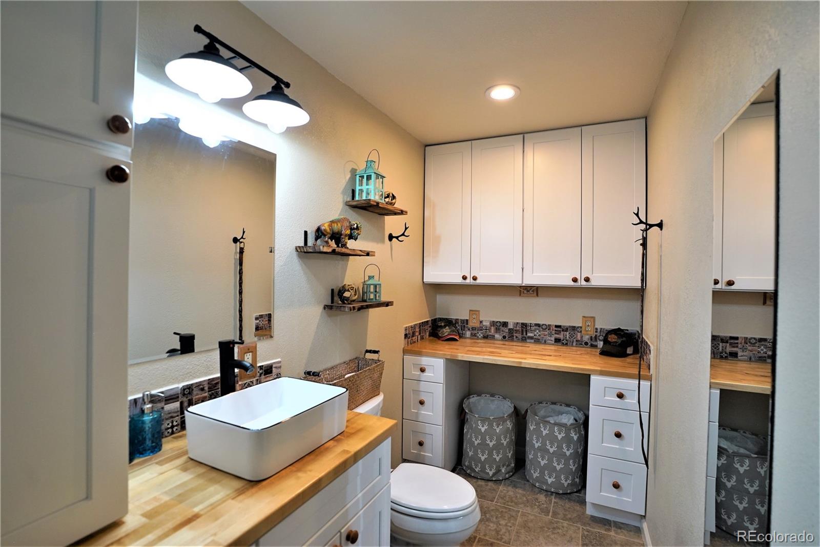 336 County Road 64 Shawnee, CO 80475 - Photo 17 of 40 a room with a sink a toilet and a mirror
