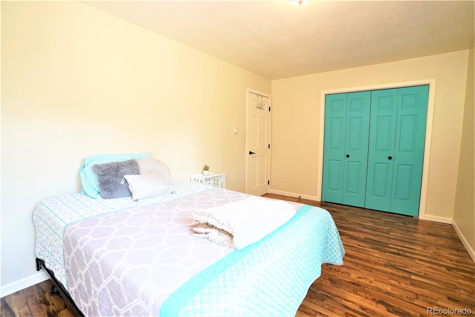 336 County Road 64 Shawnee, CO 80475 - Photo 18 of 40 a bedroom with a bed and wooden floor