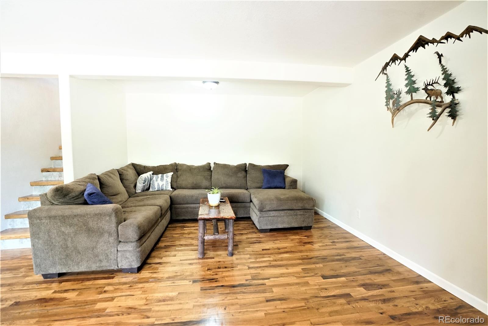 336 County Road 64 Shawnee, CO 80475 - Photo 23 of 40 a living room with furniture and a white wall with painting on the wall
