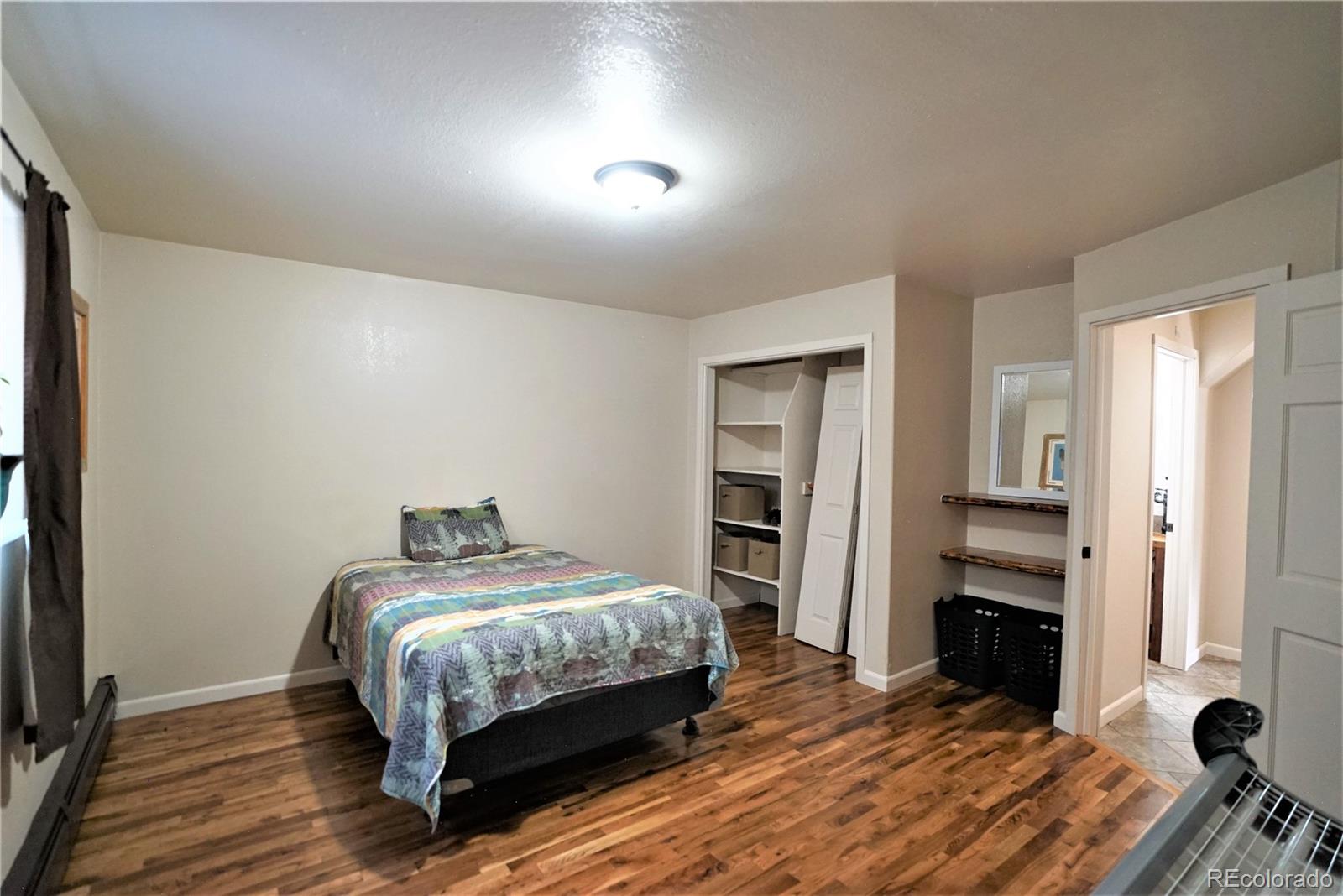 336 County Road 64 Shawnee, CO 80475 - Photo 28 of 40 a bedroom with a bed and a flat tv screen on the dresser