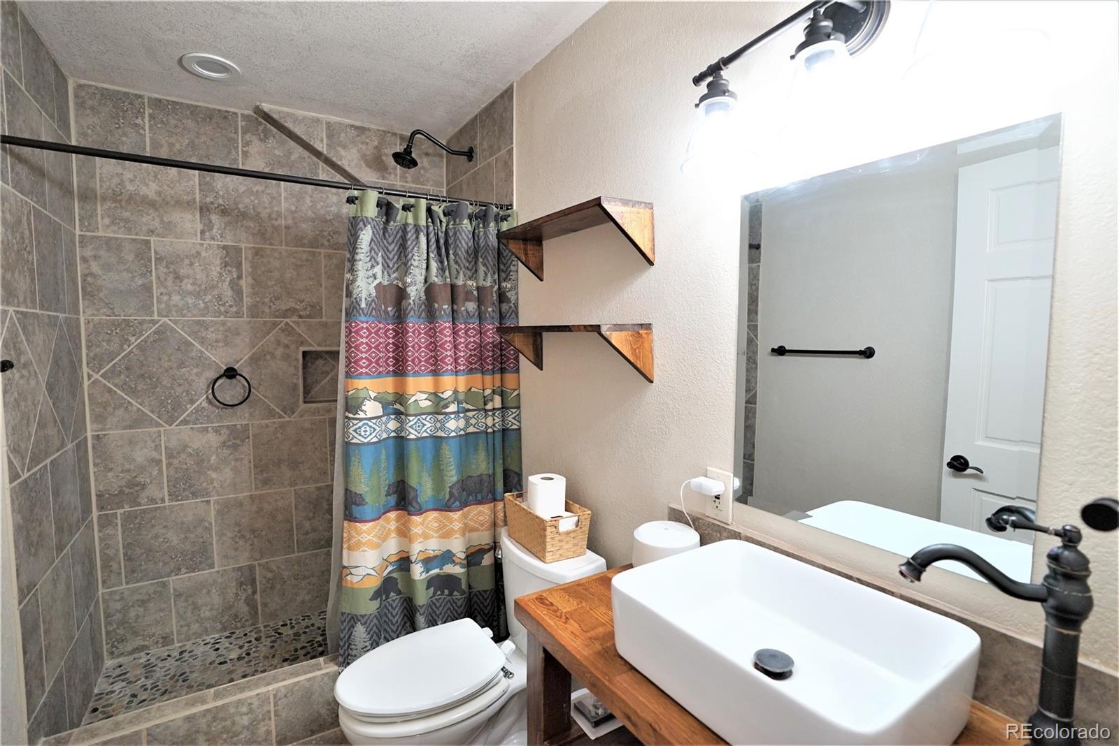 336 County Road 64 Shawnee, CO 80475 - Photo 29 of 40 a bathroom with a sink toilet and shower