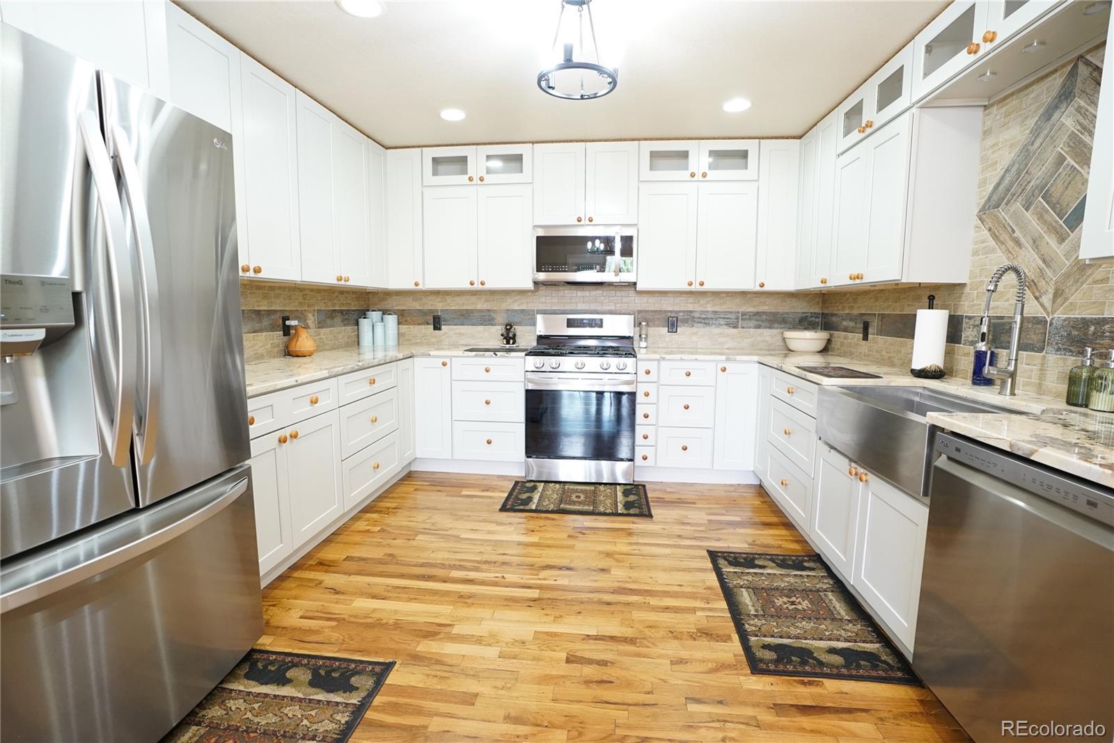 336 County Road 64 Shawnee, CO 80475 - Photo 4 of 40 a large kitchen with stainless steel appliances granite countertop a stove and a refrigerator