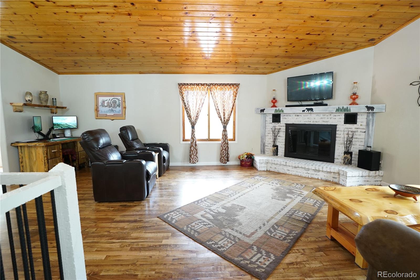 336 County Road 64 Shawnee, CO 80475 - Photo 7 of 40 a living room with furniture wooden floor and a fireplace