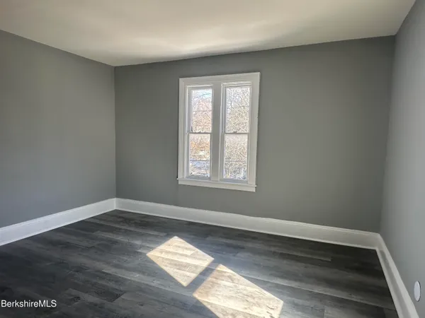 a view of wooden floor and windows in a room