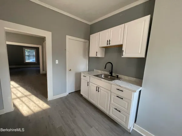 a kitchen with sink cabinets and stove
