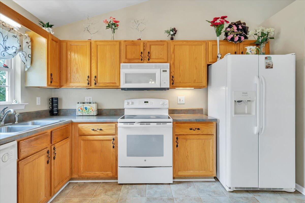 4751 Westvale Road Northeast Roanoke, VA 24019 - Photo 11 of 30 a kitchen with a white cabinets and white appliances