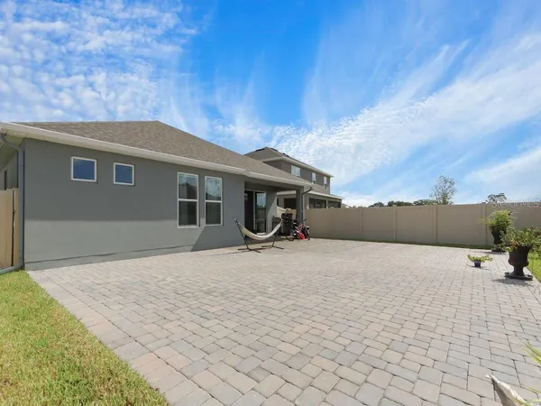 a backyard of a house with table and chairs
