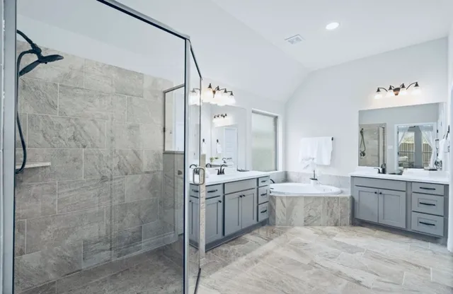 a large bathroom with a double vanity sink mirror and shower