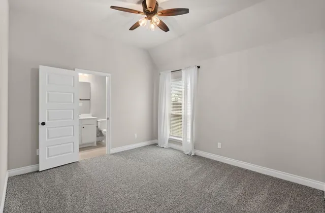 an empty room with closet and windows