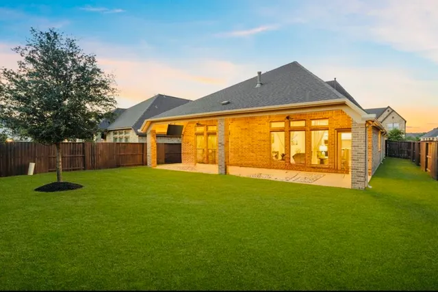 an aerial view of residential houses with outdoor space and swimming pool