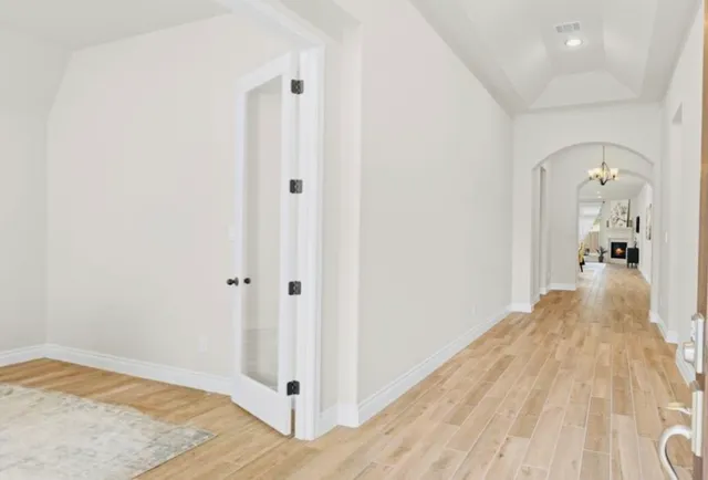 a view of a bedroom with wooden floor