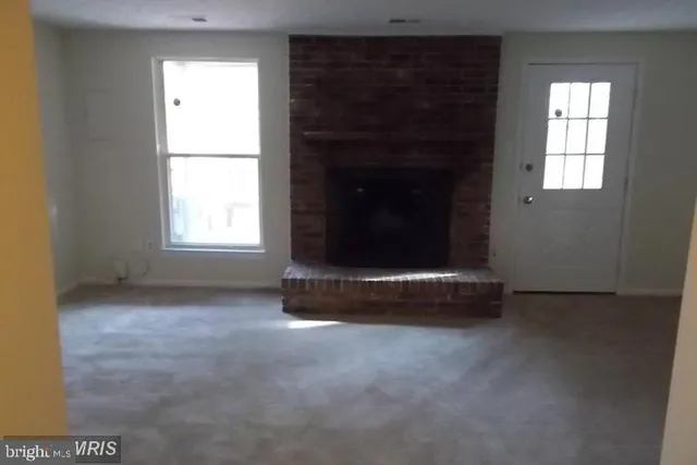 an empty room with a fireplace