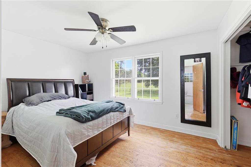 570 Wildcat Bridge Road Royston, GA 30662 - Photo 16 of 29 a bedroom with a large bed and a window