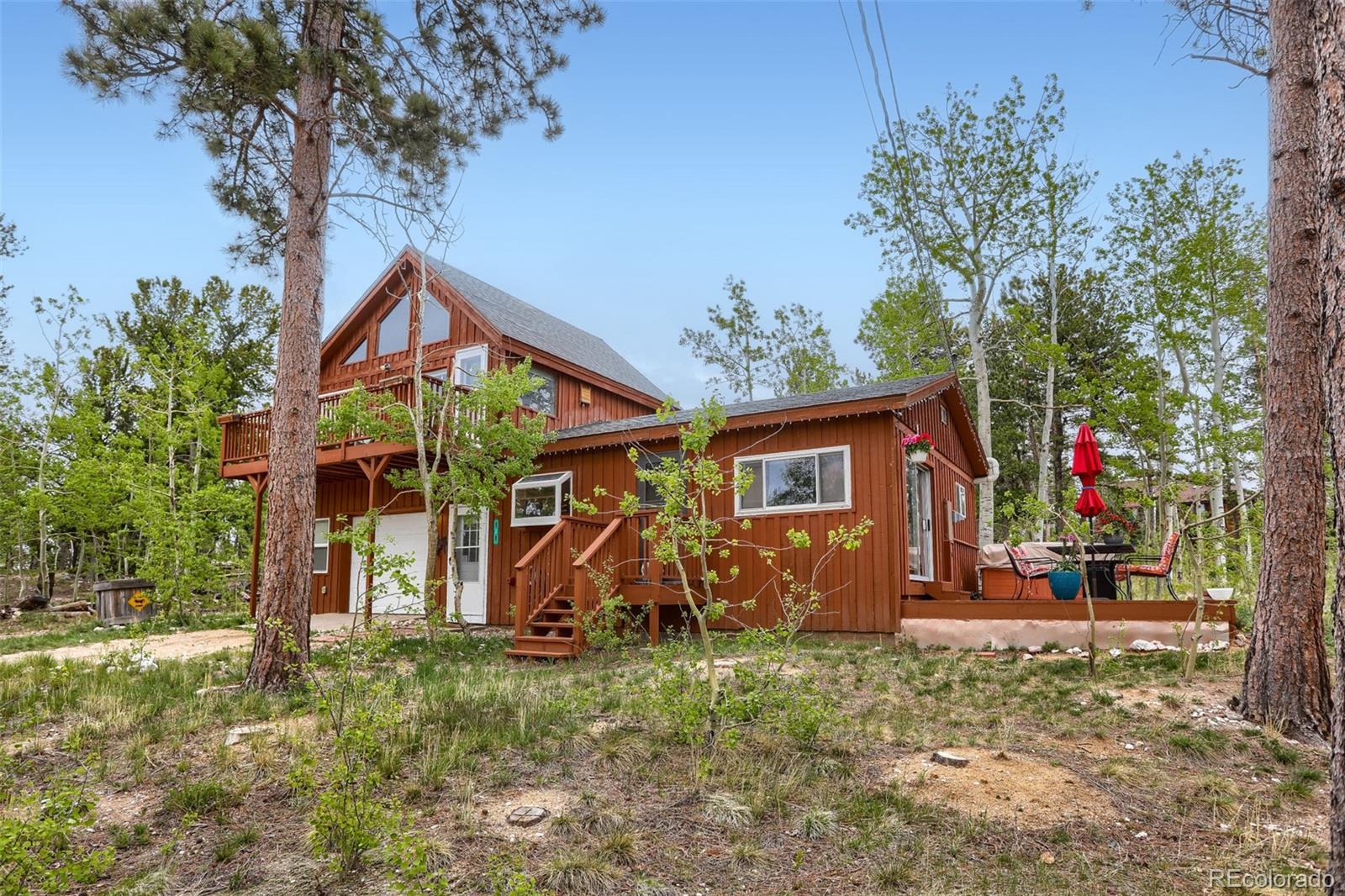 2 Debra Ann Road Golden, CO 80403 - Photo 6 of 41 a view of a wooden house with a yard and hanging chair