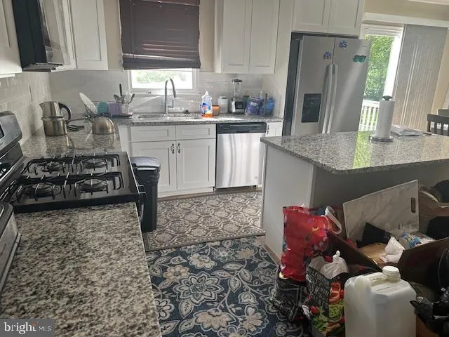 a kitchen with a sink stove and cabinets