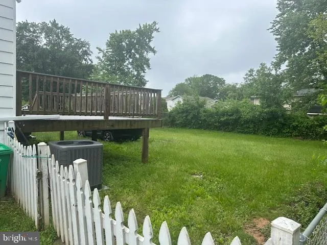 a view of a deck with a table and chairs with wooden fence