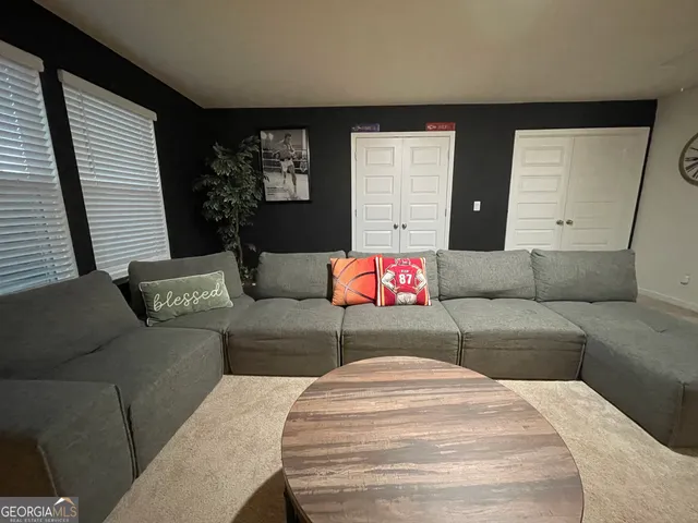 a living room with furniture and a potted plant