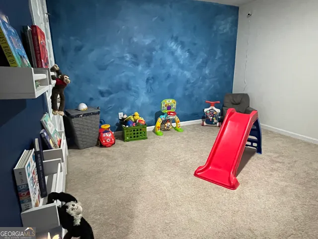 a bedroom with a bed and a large mirror