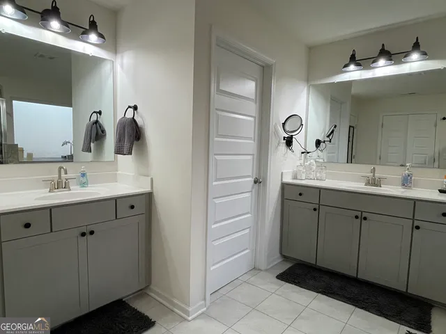 a bathroom with a tub sink and mirror