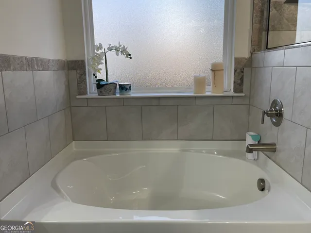 a bathroom with a shower and a bath tub