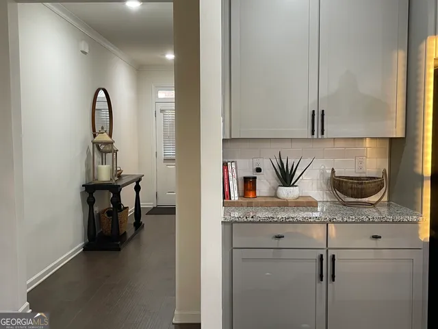 a close view of a sink a counter and cabinets in a room