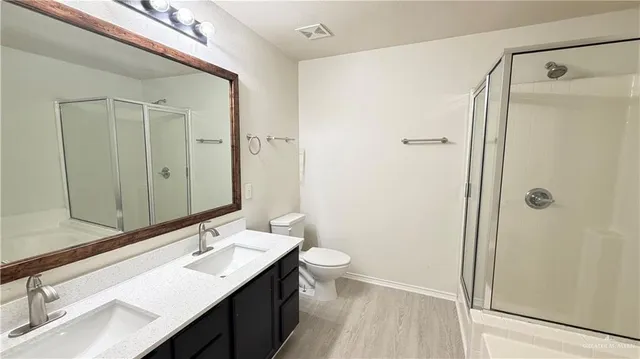 a bathroom with a double vanity sink mirror double and shower