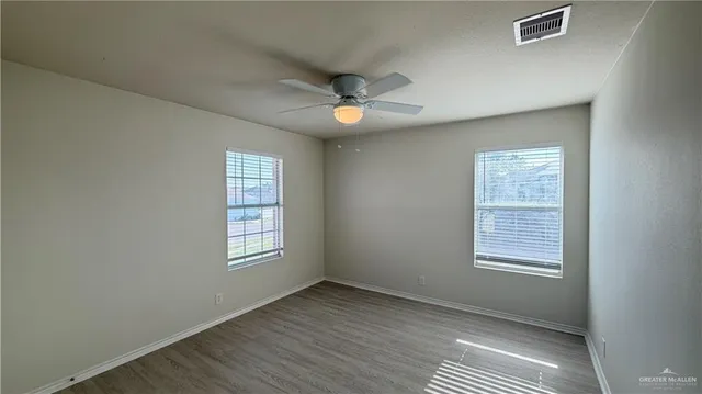 a view of an empty room with windows