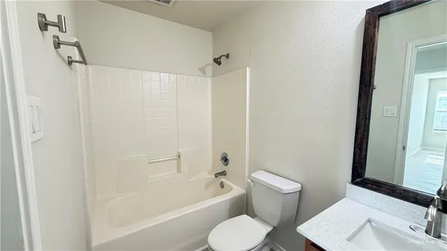a bathroom with a toilet and a bathtub