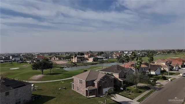 an aerial view of a residential houses with outdoor space and swimming pool