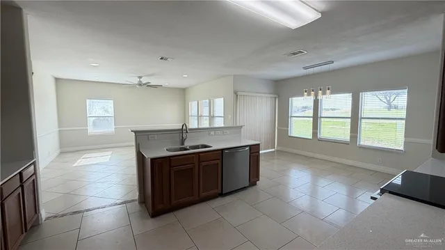 a large white kitchen with a large window